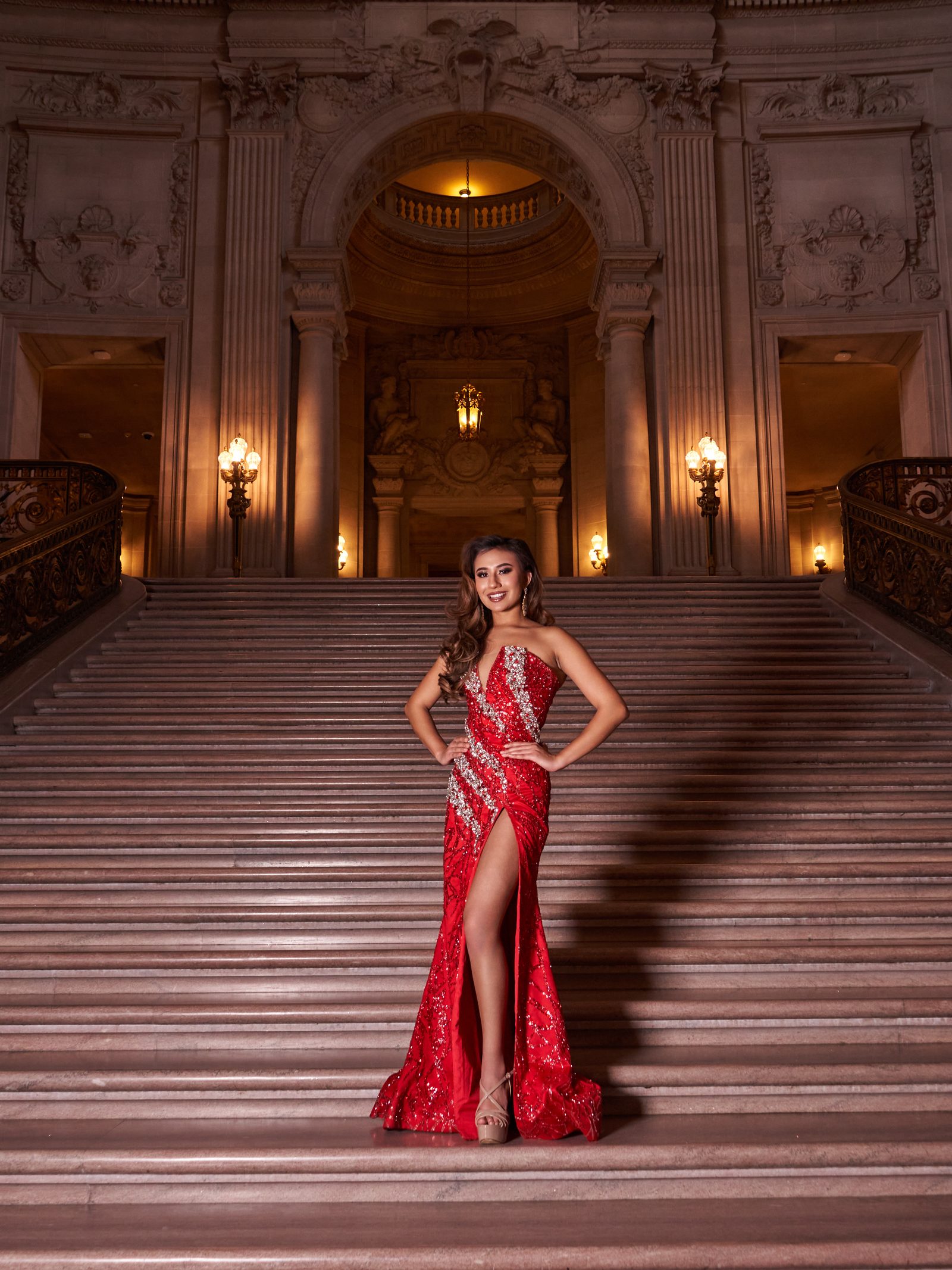 Red sequin gown at the foot of the City Hall rotunda staircase